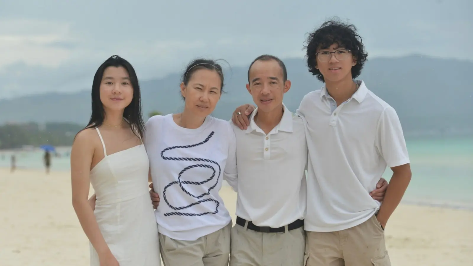 Dr. Kimberly Ahn and Dr. Reynaldo Perez with their family on a beach