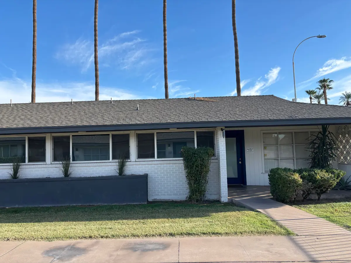 The Ahn & Perez DDS building on Mill Avenue, with the blue Suite F door on the right, under tall palm trees